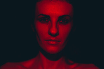 Portrait of a young woman in red light