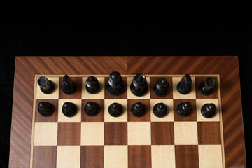 Black Chess piece over chessboard