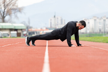 Man Doing Push Ups on Track