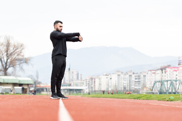 Athletic Runner Doing Stretching Exercise