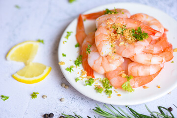 Fresh shrimps prawns seafood lemon with herbs and spice, Garlic shrimp peeled on white plate background dining table food