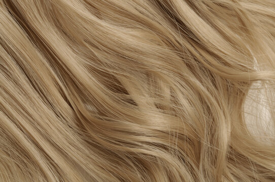 Closeup Texture Of Single Piece Clip In Wavy Honey Blonde Synthetic Hair Extensions