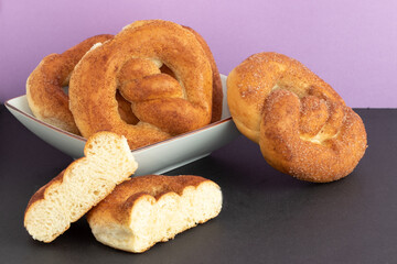 Whole and halves of cinnamon pretzels .