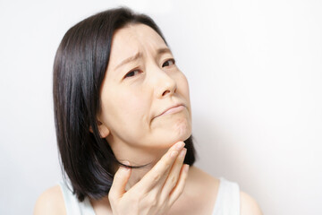 Fototapeta premium Middle-aged woman suffering from skin problems