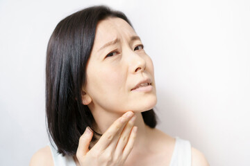 Fototapeta premium Middle-aged woman suffering from skin problems