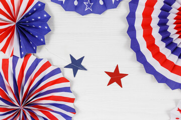 Fototapeta na wymiar Decorations for 4th of July day of American independence, flag, straws, paper fans. USA holiday decorations on a white wooden background, top view, flat lay 