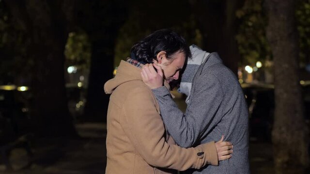 suffer together - two guys hug each other and cry  for the loss of a friend 