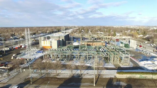 AERIAL - A power plant in winter in Ottawa, Canada, wide shot forward