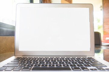 Laptop with Mock up blank screen on wooden table in front of cafe space for text. product display computer laptop montage- technology Freelance work