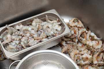 Many peeled raw headless large shrimps without shell