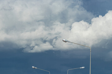 Rain clouds in the sky and street light poles