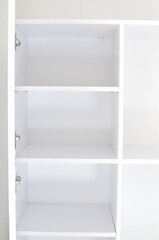 Empty white shelves of the cupbord organizer for clothes