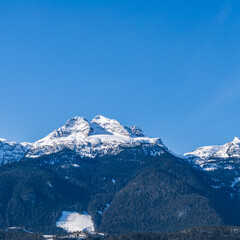 Beautiful snow-capped Columbia Mountains against the blue sky in British Columbia Canada