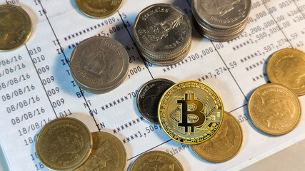 Golden coins with bitcoin symbol on bank account book, coins stack and bitcoin.