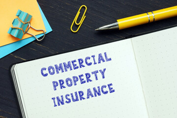 Conceptual photo about COMMERCIAL PROPERTY INSURANCE with handwritten text.