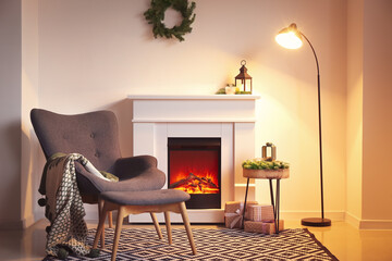 Interior of modern room with fireplace and armchair