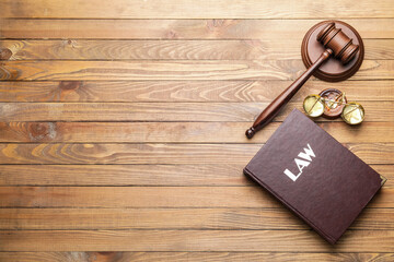 Judge's gavel with justice scales and book on wooden background - obrazy, fototapety, plakaty