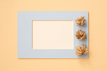 White Card for your text in a blue frame with dry aroma flowers on a beige background. Add your own text.