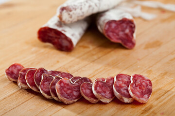 Slicing delicious Spanish smoked sausage fuete. High quality photo