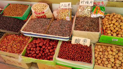 Local speciality on Wangfujing street in Beijing, China. There are lots of colorful boxes with colorful spices in them. Some of the spices are packed in plastic bags. Oriental cooking