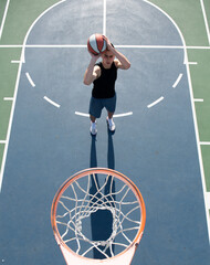 Basketball player. Sports and basketball. Man jumps and throws a ball into the basket.
