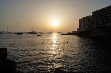 a beach on the island of Ibiza with boats at dusk on a summer night. Balearic Islands, Spain


