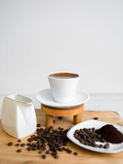 cup of coffee with white background and coffee beans