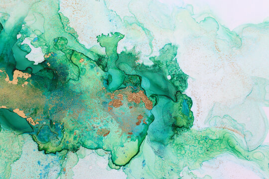 art photography of abstract fluid painting with alcohol ink, green and gold colors