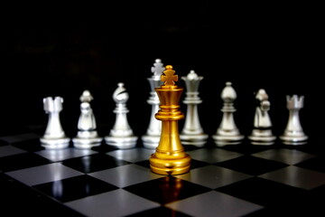 golden king chess in front of chess pieces on chess game board