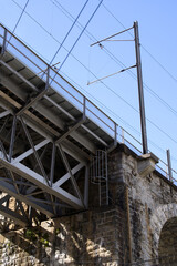 Close-up of iron railway bridge with stone pillars at industrial district at City of Zurich. Photo taken May 10th, 2021, Zurich, Switzerland.