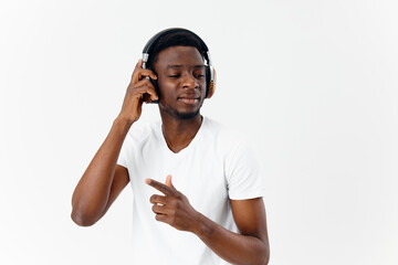 Fototapeta premium man of african appearance with closed eyes in headphones listening to music