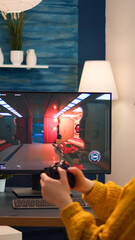 Woman esport cyber playing online game with virtual reality headset and wireless controller. Virtual shooter game championship in cyberspace, esports player performing on pc during gaming tournament © DC Studio