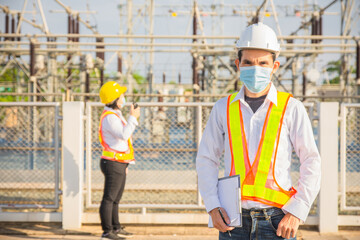 Fototapeta na wymiar Asian man wear mask protect coronavirus and work in power plant