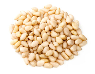pile of unpeeled pine nuts closeup on white