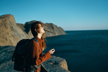 Fototapeta premium beautiful traveler with a backpack in nature near the sea