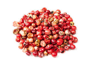 pile of pink peppercorns (Baie rose) on white