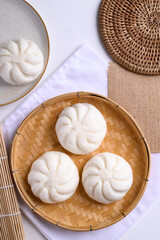 Steamed bun stuffed with minced pork on bamboo basket, Asian food