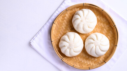 Steamed bun stuffed with minced pork on bamboo basket, Asian food