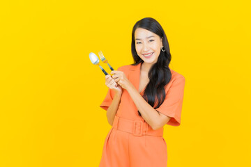 Portrait beautiful young asian woman smile with spoon and fork