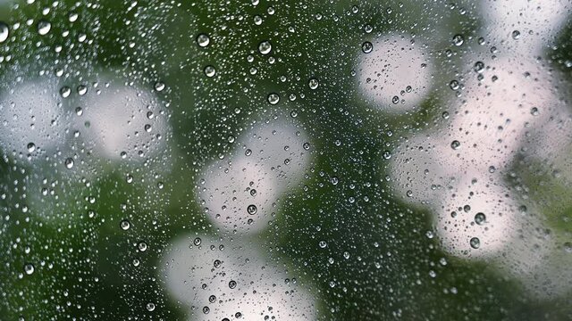 Close up droplets of the rain on window glass on a rainy day. Natural Pattern of raindrops.