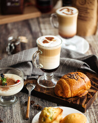 Served coffee cafe table with desserts and latte drinks