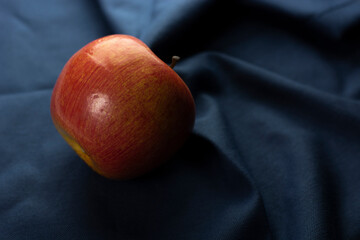 red apple on blue cloth