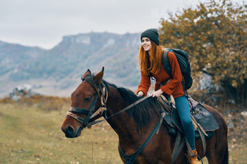 Obraz premium cheerful woman Tourist riding a horse nature mountains joy