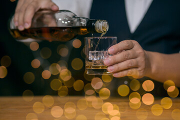 Barman pouring whiskey whiskey glass beautiful night