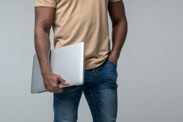 Man with laptop, face not visible
