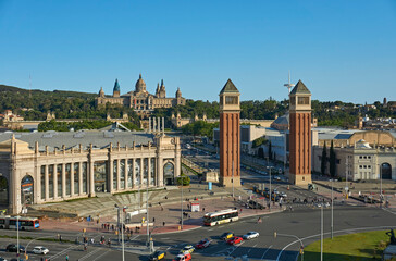 Naklejka premium Cityscape view of Venetian towers and National Palace of Montjuic, Plaça Espanya, Barcelona, Spain