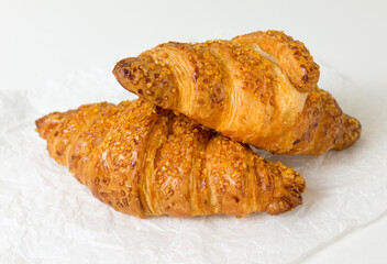  two tasty croissants on white background. French food. Close up