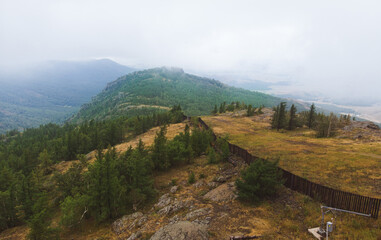 Foggy evergreen fir forest on a hilltop among the mountains of the National Park of the Republic of Bashkortostan on Lake Bannoye