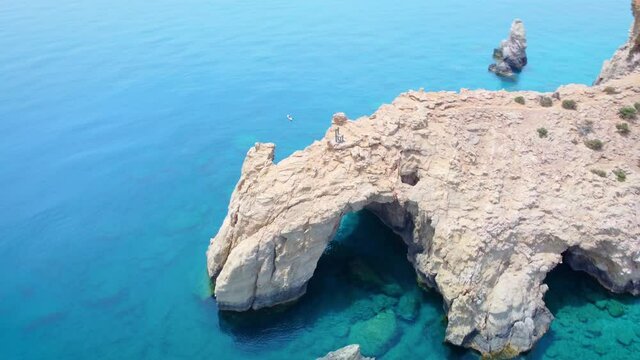 Natural bridge and chair on the beach of Tripiti in Gavdos island.