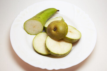 pear conference, cut into thin slices, beautifully arranged on white plate. back and front parts are bigger